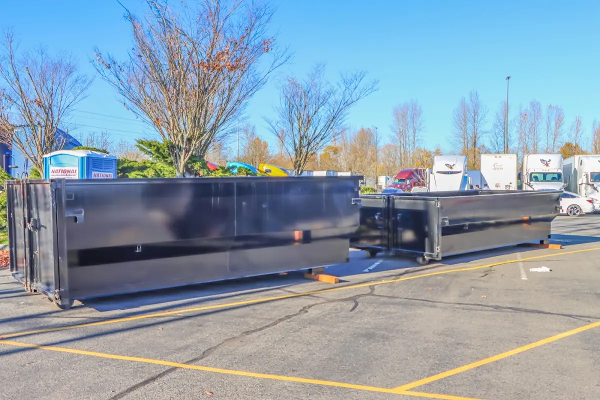 Professional dumpster rental service with roll-off container on residential driveway in Castle Pines